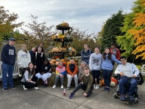Group photo of students and Allies at the Penn State Arboretum on a fall day