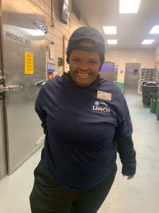 Girl smiling while working at Pollock Commons